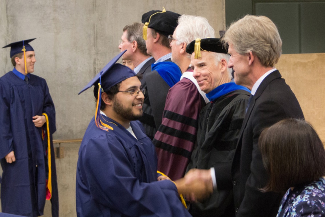 2015 Winter Commencement Students Shaking Hands with Board