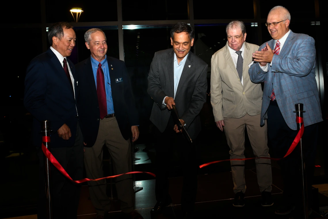 U of A President Suresh Garimella cuts the ribbon on the Grand Challenges Research Building, alongside other leaders.